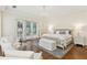 Main bedroom with a sitting area, hardwood floors, and a chandelier at 32 Prioleau St # N, Charleston, SC 29401