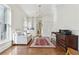Office with a sofa, wooden floors, a red patterned rug, and lots of storage at 32 Prioleau St # N, Charleston, SC 29401
