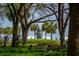 Scenic park view with lush greenery, the iconic Pineapple Fountain, mature trees, and waterfront at 32 Prioleau St # N, Charleston, SC 29401