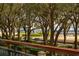 Beautiful waterfront park with mature trees, lamp post and benches for relaxing and enjoying the peaceful view at 32 Prioleau St # N, Charleston, SC 29401