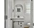 Stylish bathroom featuring a white vanity, modern fixtures, and a decorative round mirror at 33 Athens Ct, Charleston, SC 29403