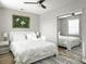 Comfortable bedroom with light walls, ceiling fan, modern art piece, closet with mirror doors, and bedside table at 33 Athens Ct, Charleston, SC 29403