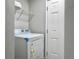 Functional laundry room with white walls, door, wire rack, and a modern washer and dryer set at 33 Athens Ct, Charleston, SC 29403