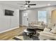 Cozy living area with wood floors, comfortable seating, and view of the bright outdoors at 33 Athens Ct, Charleston, SC 29403