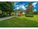 Charming home featuring a well-manicured front yard, a swing, a long driveway and a detached two-car garage at 3596 Walter Drive Dr, Johns Island, SC 29455