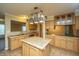 Bright kitchen featuring an island, light wood cabinets, granite countertops, and pendant lighting above island at 3596 Walter Drive Dr, Johns Island, SC 29455