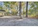 Open backyard with mature trees, a shed and a hammock at 402 Corey Blvd, Summerville, SC 29483