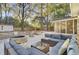 Relaxing backyard with a fire pit, outdoor seating, a hammock, and leafy ground cover at 402 Corey Blvd, Summerville, SC 29483