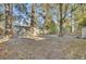 Large, shady backyard featuring a hammock, shed, back porch with lounge seating and leafy ground cover at 402 Corey Blvd, Summerville, SC 29483