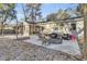 Open backyard area with a fire pit, chairs, built in hot tub and a covered porch with outdoor seating at 402 Corey Blvd, Summerville, SC 29483