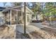Inviting backyard with a screened porch, concrete patio with lounge seating, and leafy ground cover at 402 Corey Blvd, Summerville, SC 29483