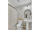 Well-lit bathroom with pedestal sink, arched mirror, and floral shower curtain at 402 Corey Blvd, Summerville, SC 29483
