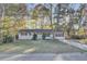 Charming single-story home with a blue door, well-manicured lawn and mature trees, creating a welcoming curb appeal at 402 Corey Blvd, Summerville, SC 29483