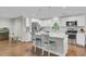 Bright kitchen with stainless steel appliances, island with marble countertop, and hardwood floors at 402 Corey Blvd, Summerville, SC 29483