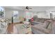 Spacious living room with hardwood floors, a comfortable gray sectional, and ample natural light creating a warm atmosphere at 402 Corey Blvd, Summerville, SC 29483