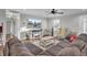 Inviting living room with a cozy gray sectional, hardwood floors, and a modern entertainment center with an electric fireplace at 402 Corey Blvd, Summerville, SC 29483