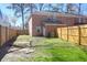 This backyard has privacy fencing, grass, and a brick house facade at 406 Crestview Dr # D, Summerville, SC 29485