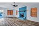 Living room showcasing hardwood floors, a unique blue fireplace, and three windows providing natural light at 425 Miami St # A, Ladson, SC 29456