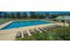 Community pool and lounge area with plenty of seating, green space, and tennis courts at 425 Verbena Ave, Summerville, SC 29483