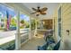 Relaxing front porch with comfortable seating, a decorative ceiling fan, and a view of the tree-lined street at 425 Verbena Ave, Summerville, SC 29483