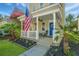 Charming front porch features cozy seating, a vibrant blue door, and lush landscaping for a welcoming entrance at 425 Verbena Ave, Summerville, SC 29483