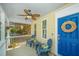 Cozy front porch with blue chairs, a decorative wreath, and a ceiling fan, creating a charming and inviting outdoor space at 425 Verbena Ave, Summerville, SC 29483