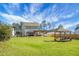 Large backyard with manicured lawn, privacy fence, and a cozy pergola, perfect for outdoor living at 436 Blue Elderberry, Moncks Corner, SC 29461