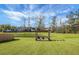 Beautiful backyard features a deck with seating, a fire pit, and a scenic pond view at 436 Blue Elderberry, Moncks Corner, SC 29461