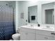 Bright bathroom features double vanity, framed mirrors, and a shower with a modern patterned curtain at 436 Blue Elderberry, Moncks Corner, SC 29461