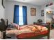 Comfortable bedroom features a full bed, dark wood furniture, natural light, and decorated with American themed artwork at 436 Blue Elderberry, Moncks Corner, SC 29461