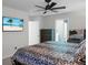 Bright bedroom with ceiling fan, modern TV, natural light, and a comfortable bed with patterned bedding at 436 Blue Elderberry, Moncks Corner, SC 29461