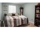 Comfortable bedroom with a striped bedspread, decorative pillows, and natural light at 436 Blue Elderberry, Moncks Corner, SC 29461