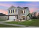 Charming two-story home with manicured lawn, stone accents, and a welcoming front entrance, perfect for a growing Gathering at 436 Blue Elderberry, Moncks Corner, SC 29461