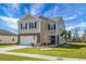 Inviting two-story home with a well-maintained lawn, stylish stone accents, and a convenient attached two-car garage at 436 Blue Elderberry, Moncks Corner, SC 29461