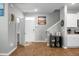 Inviting foyer area with modern decor, hardwood floors, and a view of the staircase and the adjacent kitchen area at 436 Blue Elderberry, Moncks Corner, SC 29461
