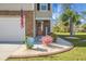 Inviting front entrance with stone accents, a well-manicured lawn, and a charming display of seasonal decorations and landscaping at 436 Blue Elderberry, Moncks Corner, SC 29461