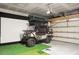 Garage features a black and silver golf cart, golf putting area and storage shelving at 436 Blue Elderberry, Moncks Corner, SC 29461
