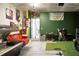 Finished garage with golf simulator, putting green, red couch, wall decorations, and sports theme at 436 Blue Elderberry, Moncks Corner, SC 29461