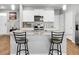 Well-equipped kitchen with granite countertops, stainless steel appliances, and stylish bar stools at 436 Blue Elderberry, Moncks Corner, SC 29461