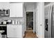 Pantry and modern appliances with granite countertops, bright white cabinets and hardwood floors at 436 Blue Elderberry, Moncks Corner, SC 29461