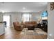 Spacious living room features hardwood floors, comfortable leather furniture, a decorative rug, and abundant natural light at 436 Blue Elderberry, Moncks Corner, SC 29461
