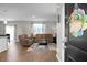 Comfortable living room with wood floors, leather furniture, and plenty of natural light streaming in from the nearby windows at 436 Blue Elderberry, Moncks Corner, SC 29461