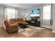 Inviting living room featuring a brown leather sofa, recliner, and a stylish area rug on a hardwood floor at 436 Blue Elderberry, Moncks Corner, SC 29461