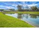 A serene pond reflecting the sky and surrounding greenery, enhancing the property's natural beauty at 436 Blue Elderberry, Moncks Corner, SC 29461