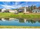Scenic backyard view featuring a tranquil pond reflecting the surrounding homes and lush greenery at 436 Blue Elderberry, Moncks Corner, SC 29461