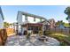 Beautiful backyard with a stone fire pit, pergola, patio, and well-kept lawn ideal for outdoor entertaining at 467 Nelliefield Trl, Wando, SC 29492
