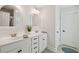 Bathroom with double vanity sinks, white cabinets, and modern fixtures at 467 Nelliefield Trl, Wando, SC 29492
