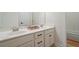 Bathroom with double vanity sinks, sleek cabinetry, and a large mirror reflecting natural light, creating a serene ambiance at 467 Nelliefield Trl, Wando, SC 29492