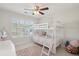 Bright bedroom features a bunk bed, plush rug, and ample natural light, creating a cozy and inviting room at 467 Nelliefield Trl, Wando, SC 29492