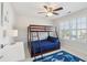 Comfortable bedroom with a bunk bed, ceiling fan, and large window, providing a restful and inviting space at 467 Nelliefield Trl, Wando, SC 29492